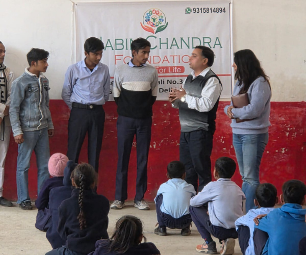 Foundation representatives speaking with children during a community session supporting our healthcare mission