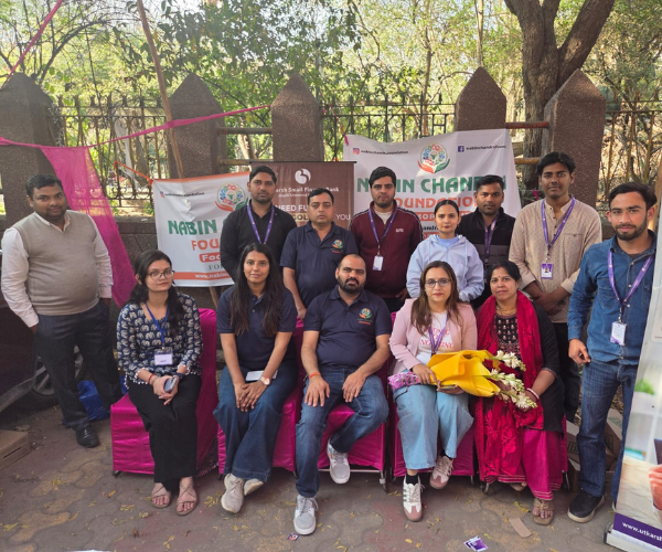 The Nabin Chandra Foundation core team seated and standing together at a community event under the Food For Life programme banner